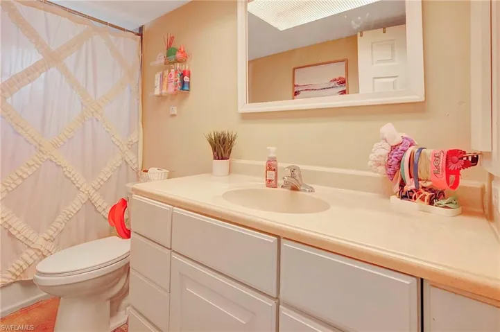 Bathroom featuring toilet and large vanity