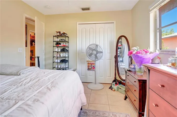 Bedroom featuring a closet and light tile floors