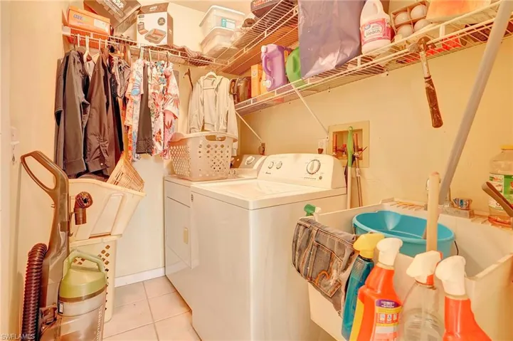 Washroom featuring independent washer and dryer, light tile floors, and washer hookup