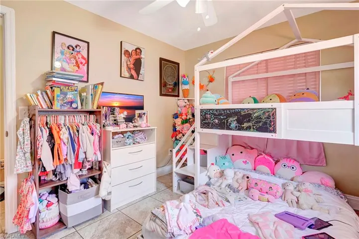 Tiled bedroom with ceiling fan