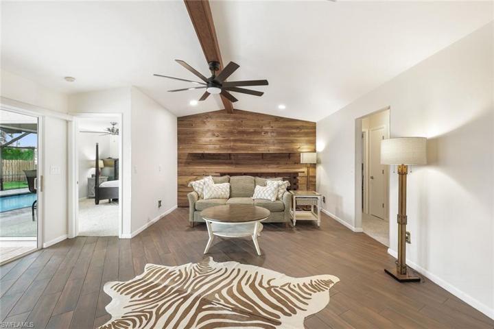 Living room with access to the primary bedroom and guest hallway