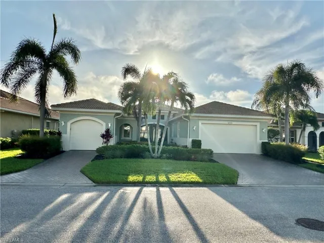 View of front facade featuring a garage and a front lawn