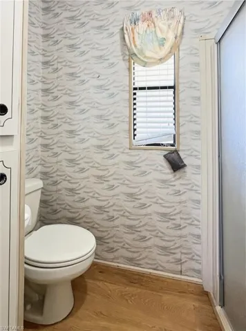 Bathroom with light wood-style floors and toilet