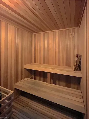 Relaxing sauna / steam room featuring wood ceiling and wood walls