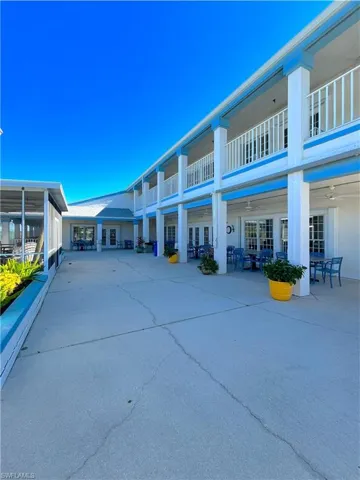 Back of property featuring french doors, a patio area, a balcony, and ceiling fan