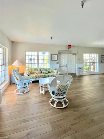 Living room with a wainscoted wall and light wood-type flooring
