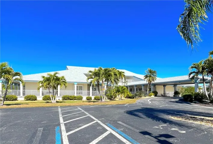 View of building exterior featuring uncovered parking