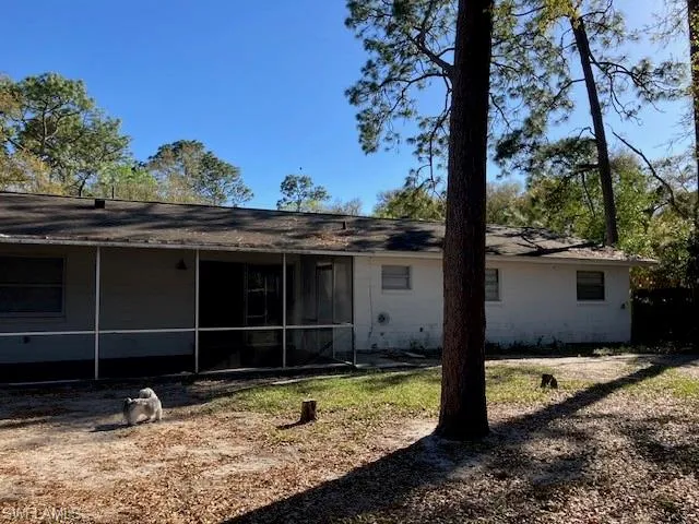 Back of property featuring a sunroom