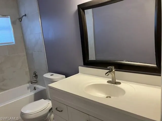 Full bath featuring bathing tub / shower combination, toilet, and vanity