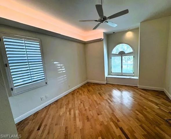 Office Unfurnishedlight wood-type flooring and ceiling fan