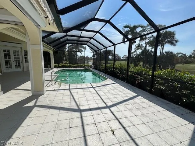 View of swimming pool with a lanai and a patio