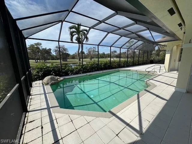 View of pool with a patio and a lanai