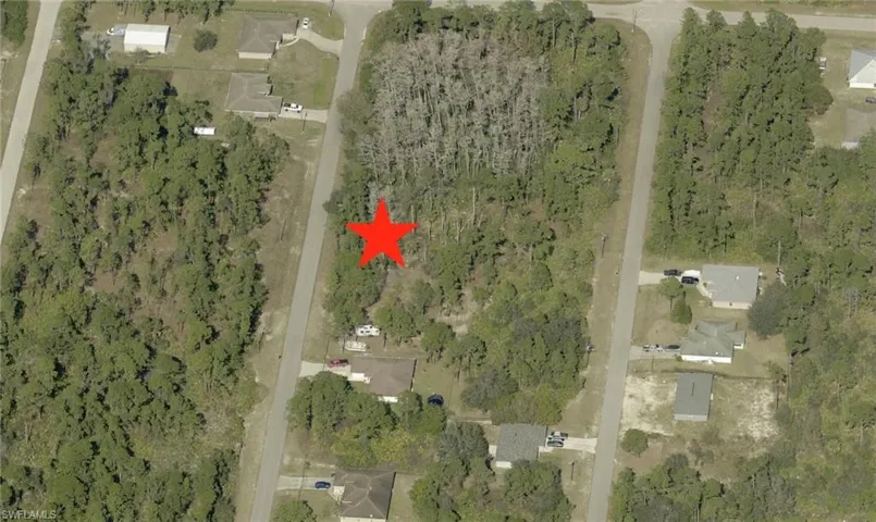 View of property location featuring a forest