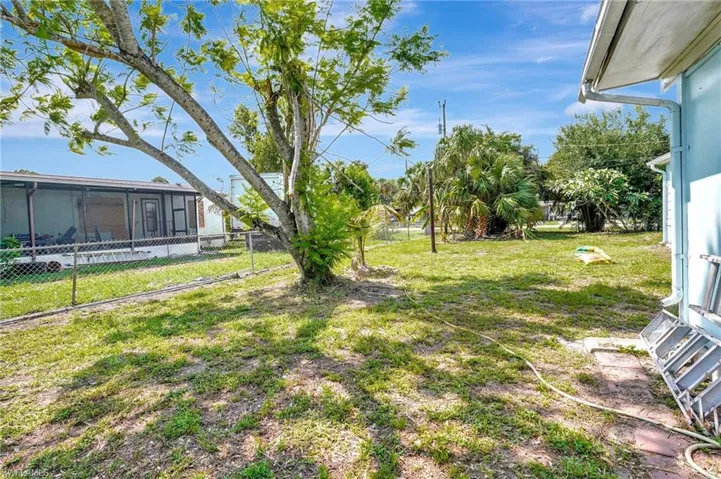 View of yard with a sunroom