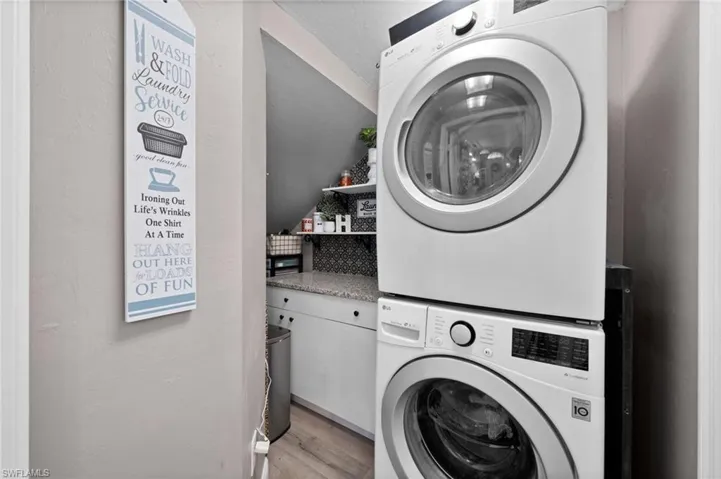 Laundry room with 2021 full size stacking LV washer dryer