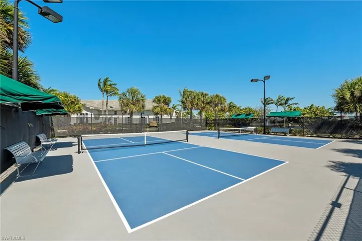 View of tennis court featuring community basketball court