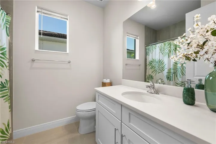Bathroom with vanity and a shower with shower curtain