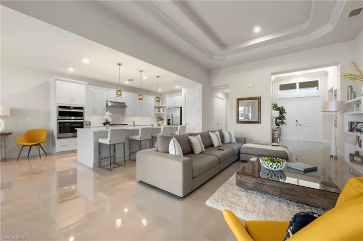 Living room with a tray ceiling and recessed lighting