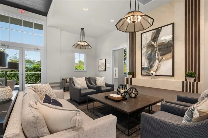 Living room with recessed lighting and a towering ceiling