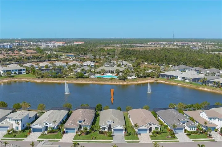 Aerial view of residential area featuring a nearby body of water