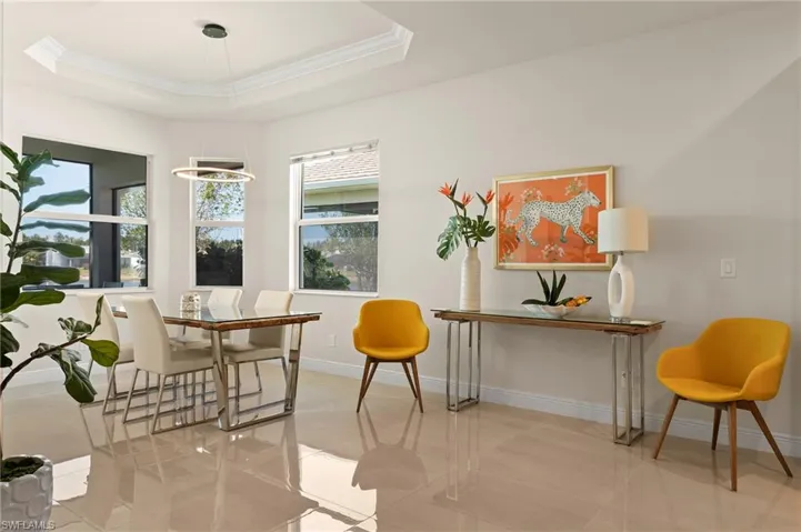 Dining room featuring ornamental molding and a tray ceiling