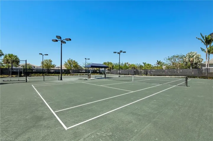 View of tennis court with community basketball court and a gazebo