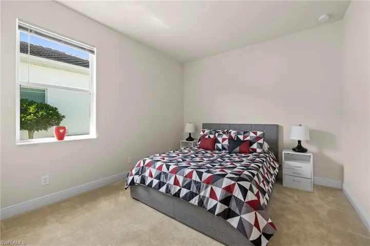 Carpeted bedroom with baseboards