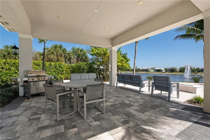 View of patio / terrace featuring a water view, outdoor dining space, grilling area, and outdoor lounge area