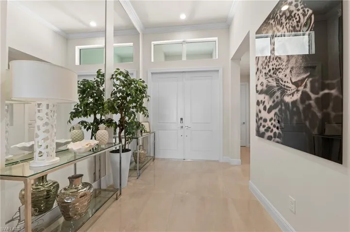 Entrance foyer with ornamental molding and recessed lighting