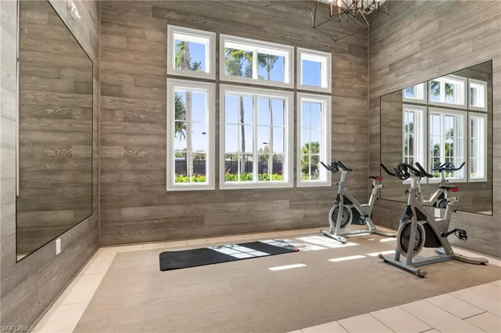 Workout room featuring a towering ceiling