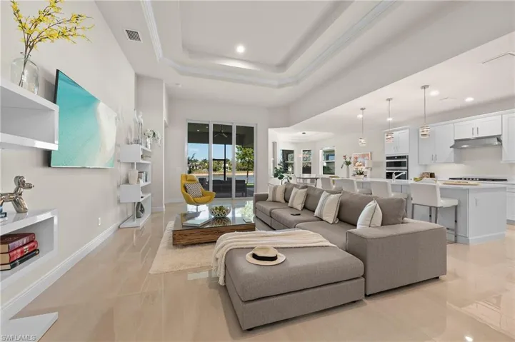 Living room with a raised ceiling and recessed lighting
