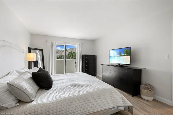 Bedroom with light wood-type flooring and access to outside