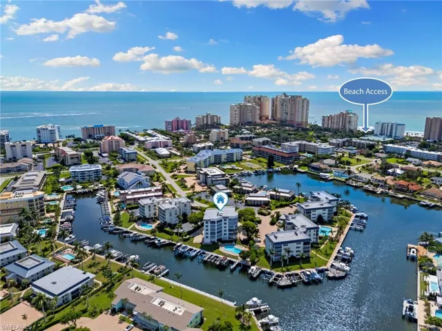 Birds eye view of property with a water view