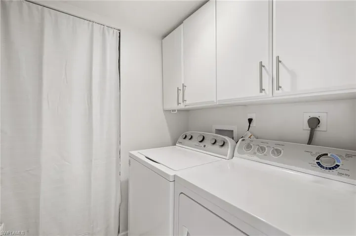 Laundry area with cabinets and washer and dryer