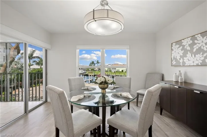 Dining room with light wood-type flooring and a water view