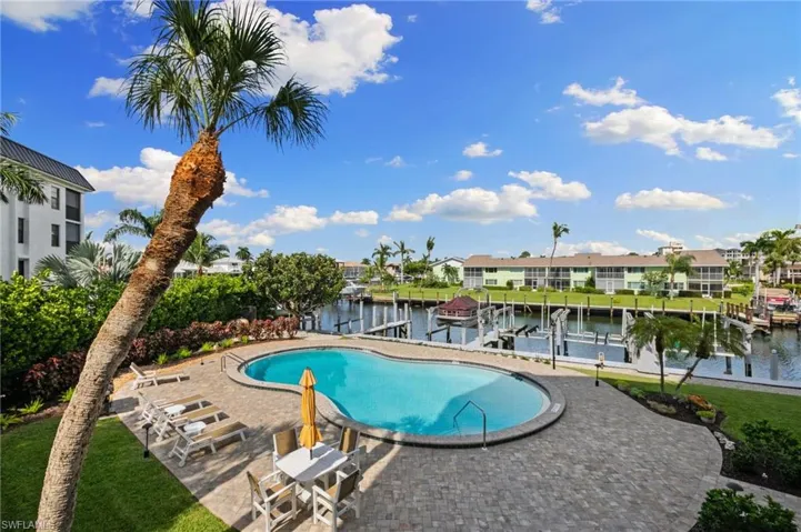 View of pool featuring a patio and a water view