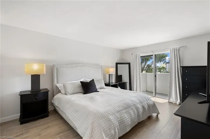 Bedroom with access to outside and light hardwood / wood-style floors