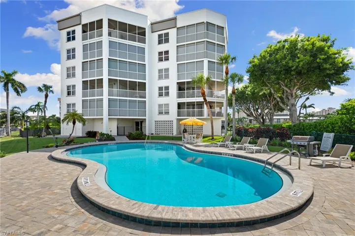 View of pool with a grill and a patio area