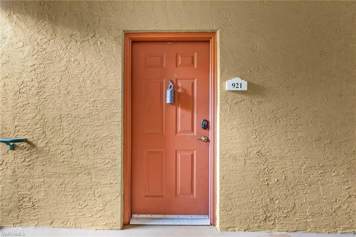 Doorway to property with stucco siding