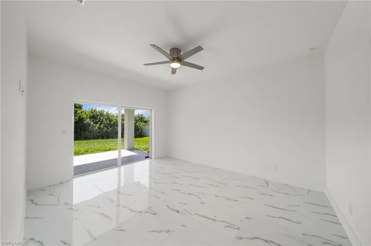 Unfurnished bedroom with light marble finish floors, a closet, and ceiling fan