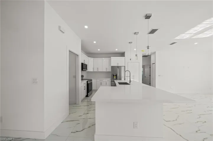 Empty room with recessed lighting, light marble finish flooring, plenty of natural light, and a ceiling fan