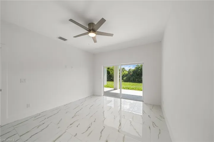 Unfurnished bedroom with a ceiling fan, a closet, and light marble finish floors