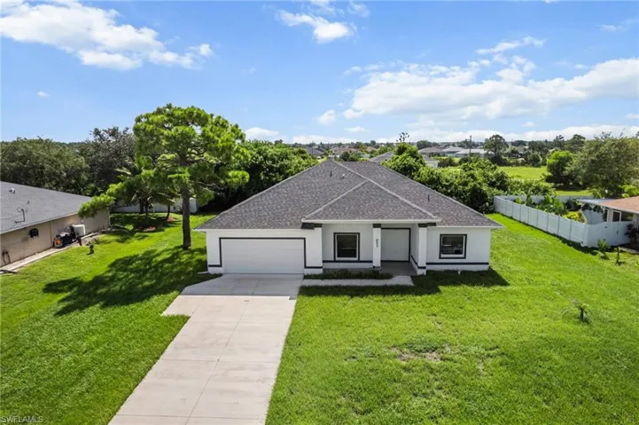 Ranch-style house featuring a shingled roof, concrete driveway, stucco siding, and an attached garage