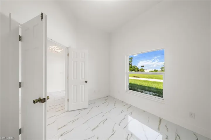 Unfurnished bedroom with ceiling fan, a closet, and light marble finish floors