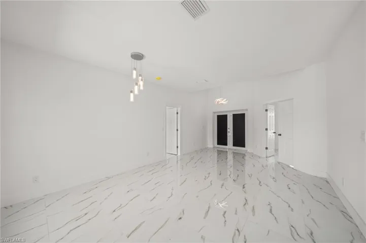 Unfurnished living room with recessed lighting, light marble finish flooring, and a ceiling fan