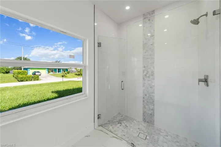 Spare room with marble finish flooring and a ceiling fan