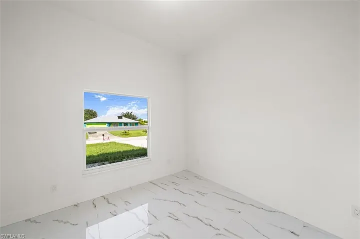 Washroom featuring light marble finish flooring and separate washer and dryer
