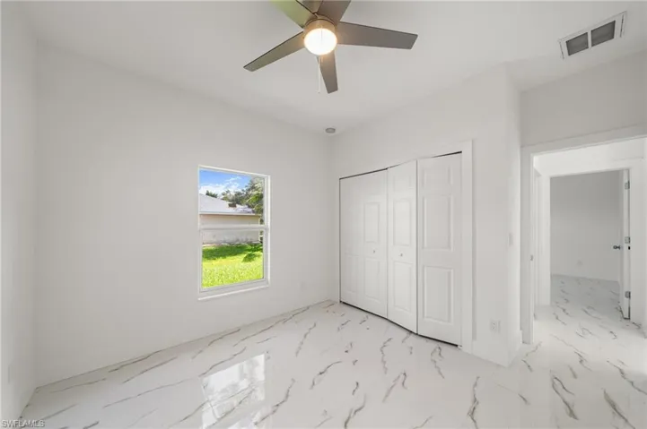 Bathroom featuring a shower stall and baseboards