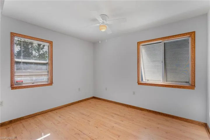 Spare room with light wood-type flooring and a ceiling fan