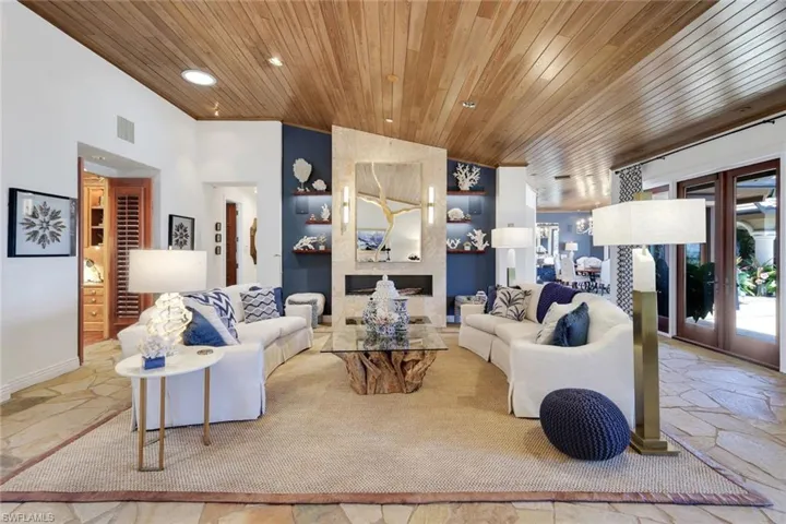 Living area featuring a natural wood plank ceiling and flagstone flooring